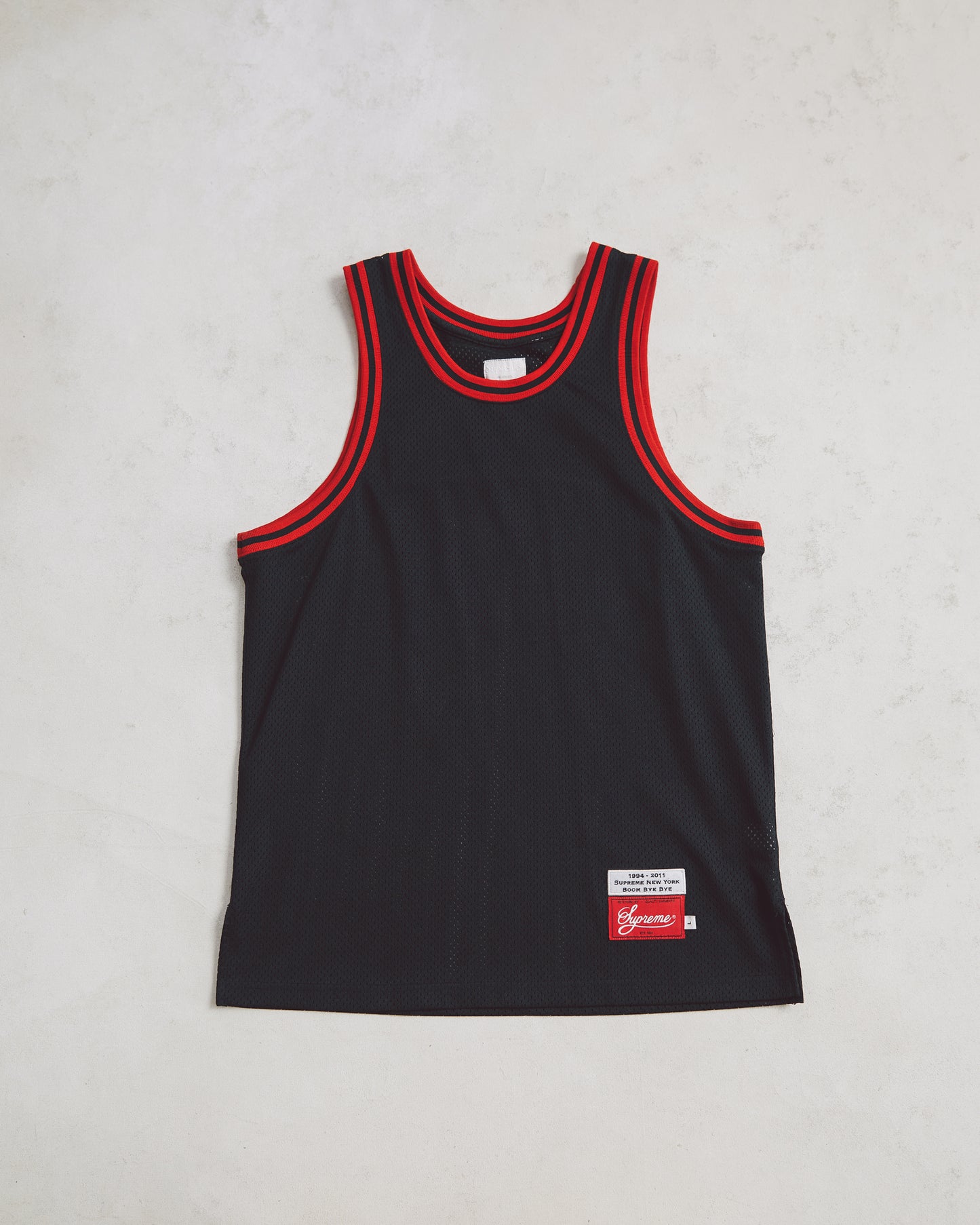 Black Supreme Basketball jersey blank on the front and #33 and world famous on the back