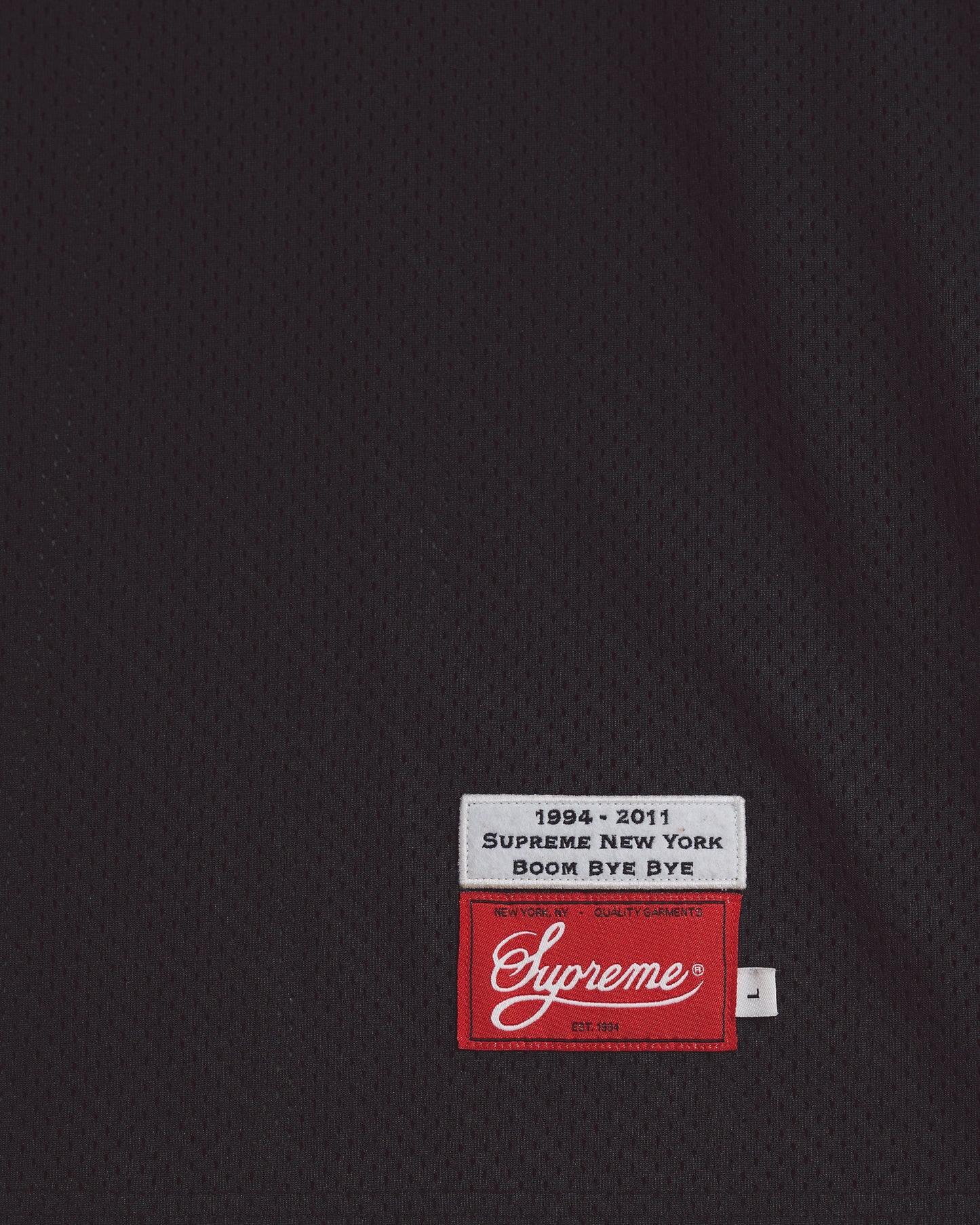 Black Supreme Basketball jersey blank on the front and #33 and world famous on the back