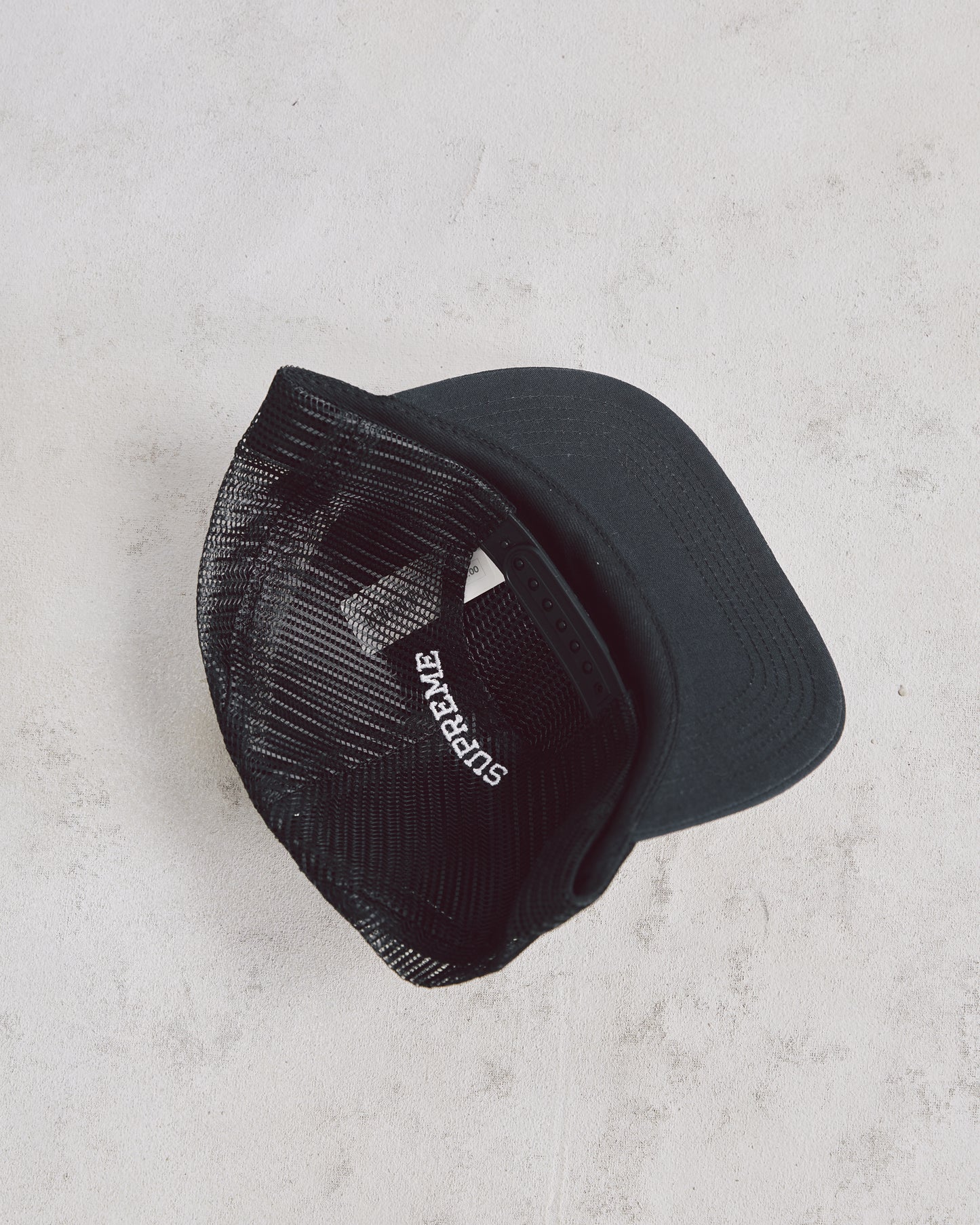 Black Supreme Trucker Hat with Red and Yellow Desert Storm Graphic